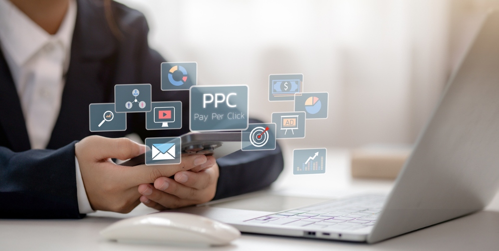 person typing on phone with marketing icons around